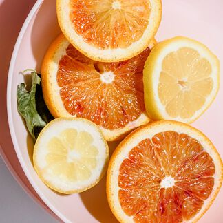 Sliced grapefruit and lemon on a pink tray